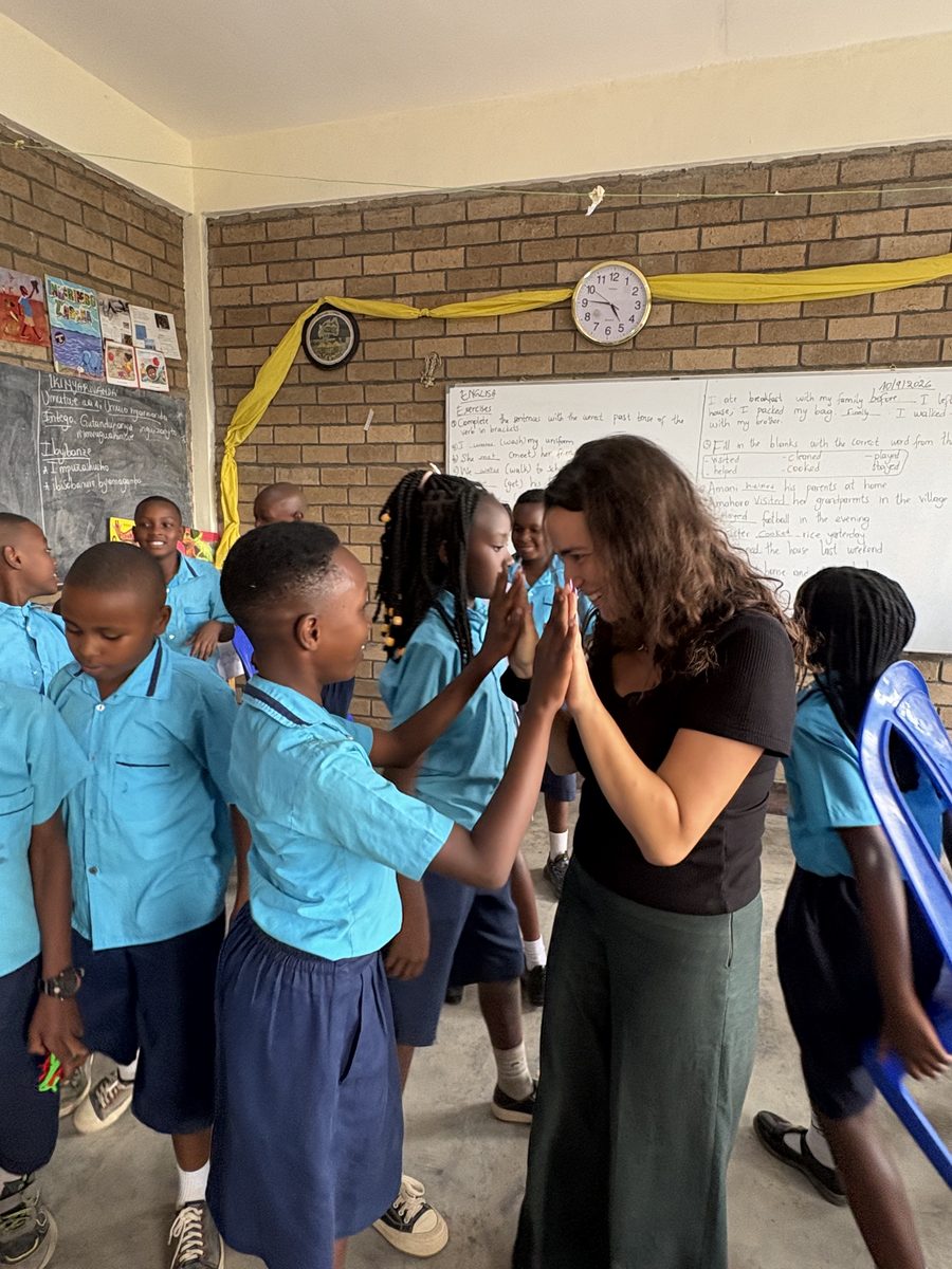 Ellen congratulating a student at Bright School, a village school near Muhanga, Rwanda